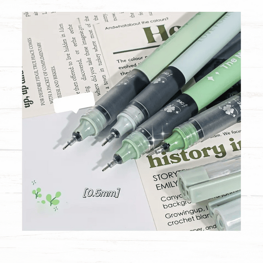 Three green gel pens on a newspaper background