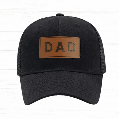 Black cap with a brown leather patch displaying 'DAD' on a white background