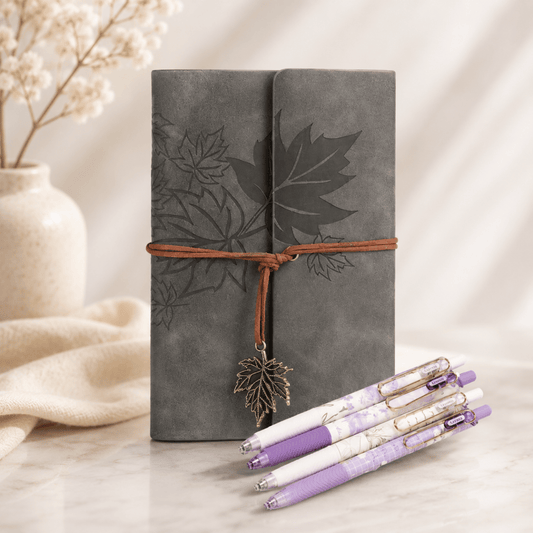 Grey faux leather leaf journal with lavender floral pens styled as a thoughtful stationery gift set on a soft neutral background.